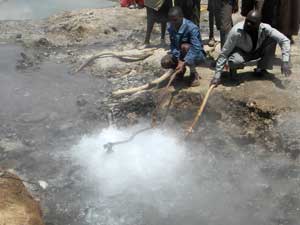 Children boil eggs at a hot spring, Lake Bogoria, Kenya, photo © by Michael Plagens